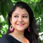 woman in black cardigan smiling